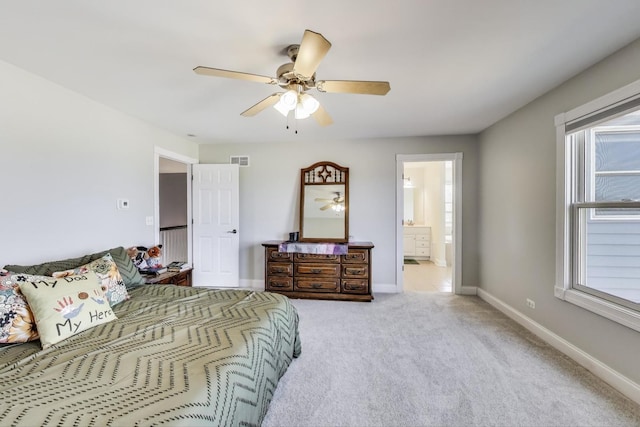 bedroom with visible vents, ceiling fan, baseboards, light carpet, and ensuite bathroom