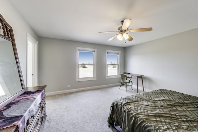 bedroom featuring baseboards, light colored carpet, and ceiling fan