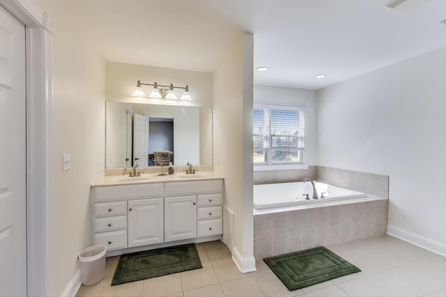 bathroom with tile patterned flooring, double vanity, a bath, and a sink