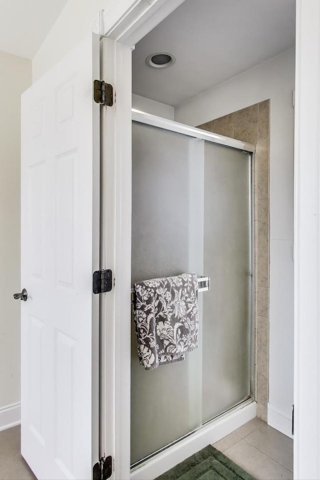 bathroom featuring tile patterned floors and a shower stall