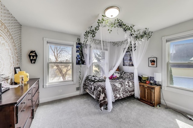 bedroom featuring baseboards and light colored carpet