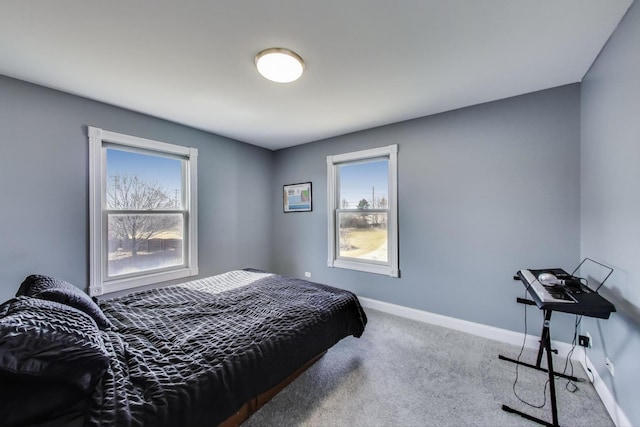 bedroom featuring carpet flooring and baseboards