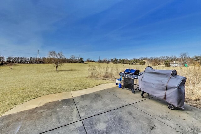 view of yard featuring a patio and a rural view