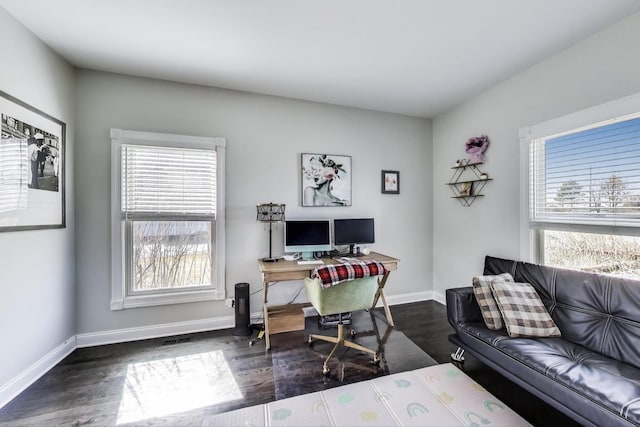 office area with visible vents, baseboards, and wood finished floors