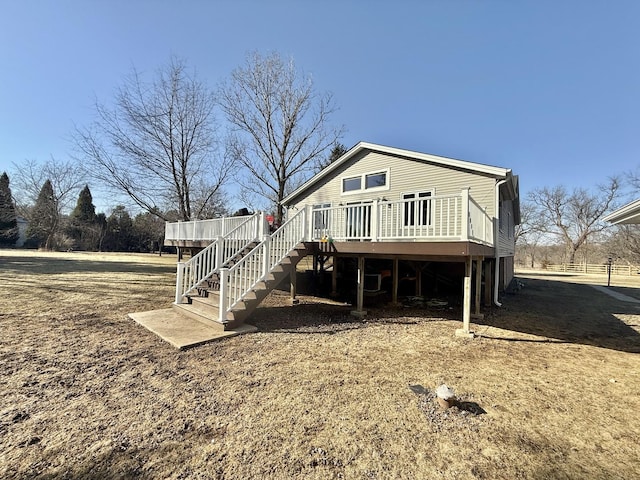 back of house with stairway and a wooden deck