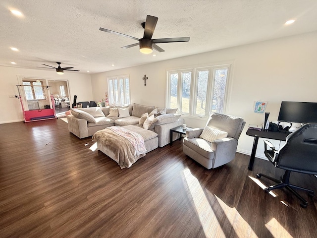 living room with a textured ceiling, a healthy amount of sunlight, and dark wood finished floors