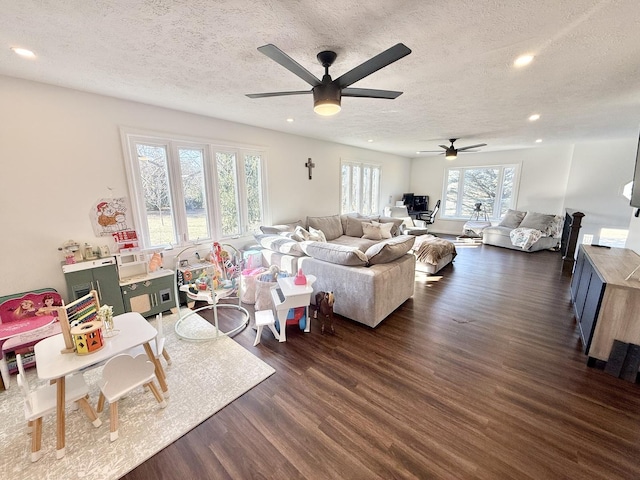 living area with dark wood-style floors, recessed lighting, a textured ceiling, and ceiling fan