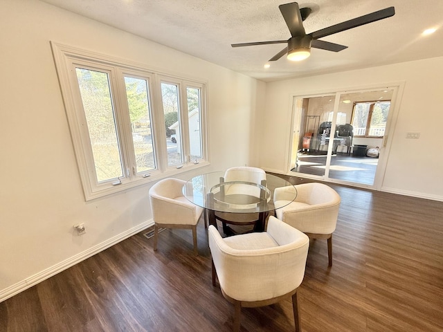 living area featuring ceiling fan, wood finished floors, baseboards, and a textured ceiling