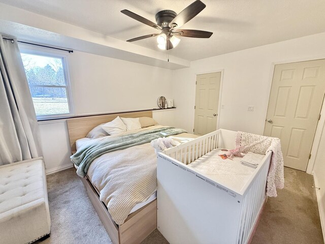 bedroom with light colored carpet and ceiling fan