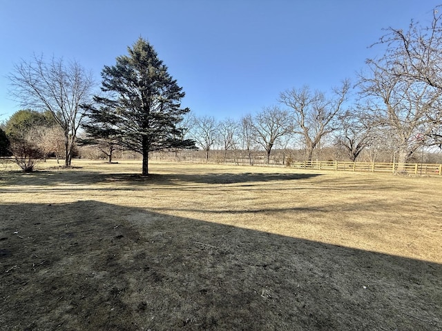 view of yard featuring a rural view and fence