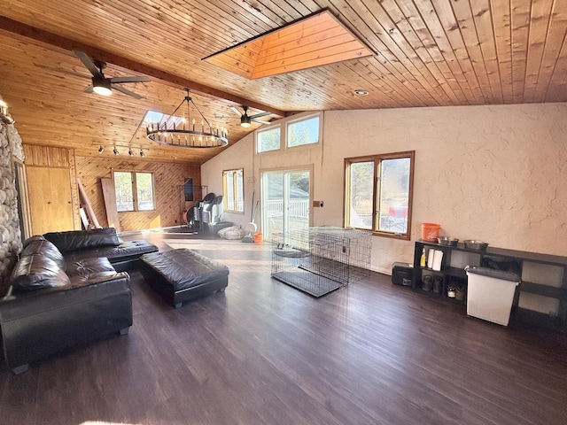 living area with wood ceiling, wood finished floors, beam ceiling, a textured wall, and a ceiling fan