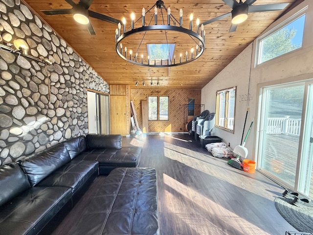 unfurnished living room with wood finished floors, a healthy amount of sunlight, wooden ceiling, and ceiling fan with notable chandelier