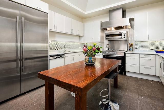 680 N Lake Shore Dr Unit 1602, Chicago, IL 60611 - kitchen with stainless steel appliances, wall chimney range hood, light countertops, a sink, and white cabinets
