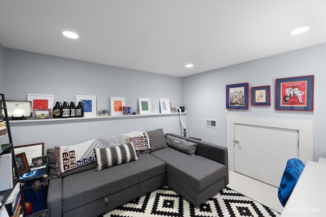 living area with recessed lighting and visible vents