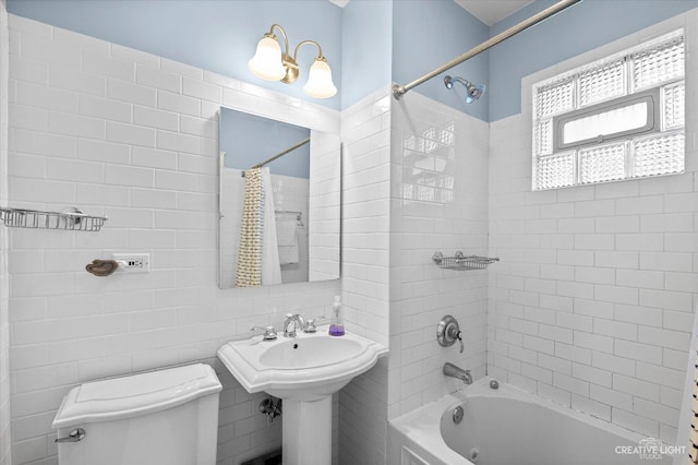 full bathroom with toilet, shower / tub combo with curtain, and a sink