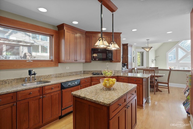 kitchen featuring a sink, paneled dishwasher, a peninsula, brown cabinetry, and black microwave