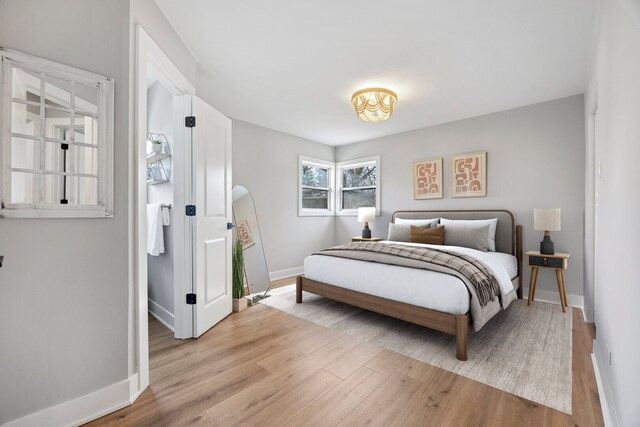 bedroom featuring light wood-type flooring and baseboards