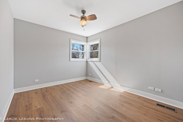 unfurnished room with visible vents, baseboards, light wood-style flooring, and a ceiling fan