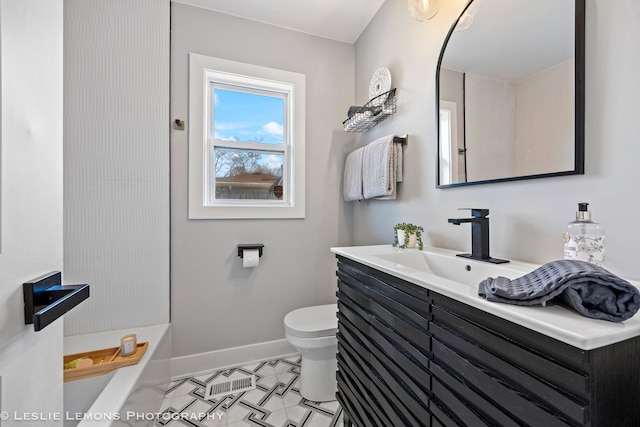 full bath featuring toilet, vanity, baseboards, and a tub to relax in