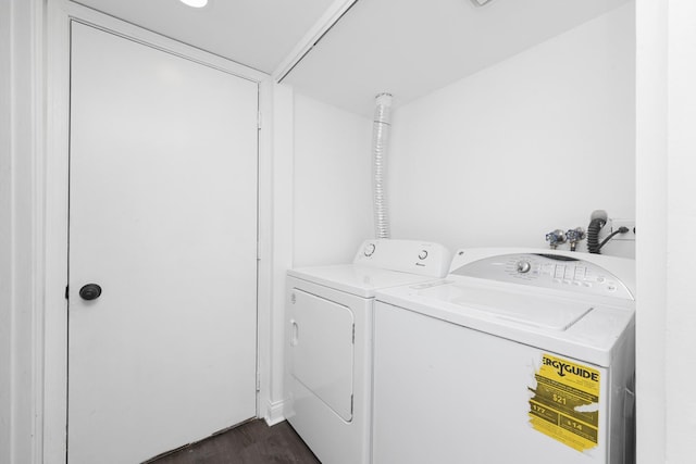 laundry room with separate washer and dryer, dark wood-style floors, and laundry area