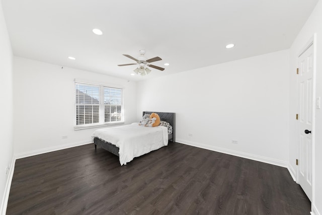 unfurnished bedroom with recessed lighting, baseboards, and dark wood-style flooring