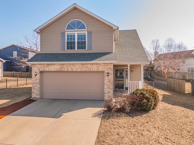 traditional home featuring brick siding, driveway, roof with shingles, and fence