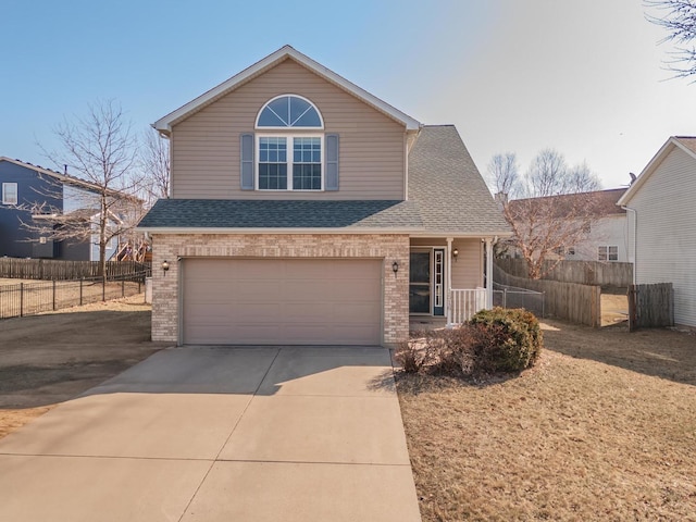 traditional home with brick siding, fence, concrete driveway, roof with shingles, and a garage