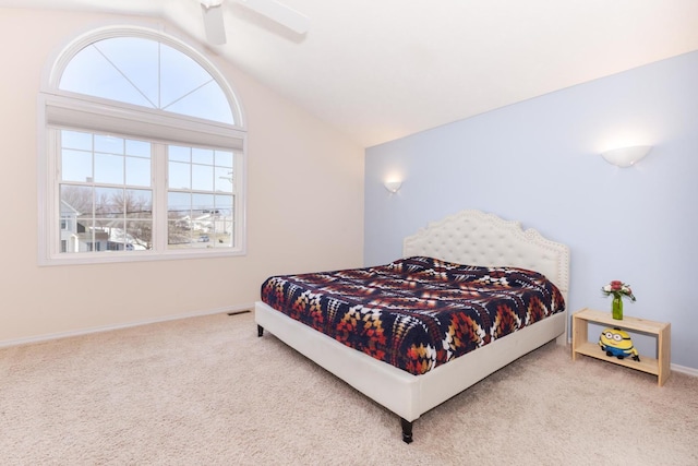 carpeted bedroom featuring baseboards, ceiling fan, and vaulted ceiling