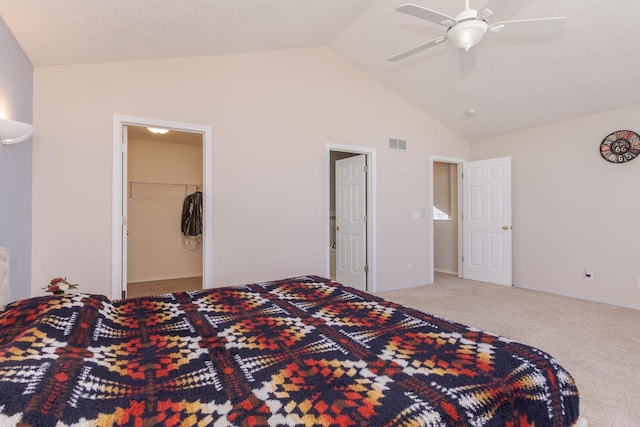 bedroom featuring visible vents, a walk in closet, carpet floors, baseboards, and ceiling fan