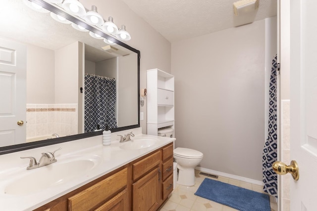 full bath with a sink, visible vents, a textured ceiling, and double vanity