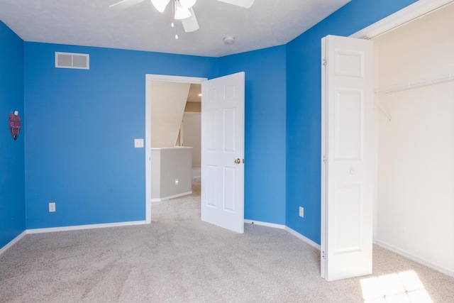 unfurnished bedroom with visible vents, carpet flooring, baseboards, and ceiling fan