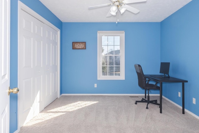 office area with a ceiling fan, baseboards, and carpet floors