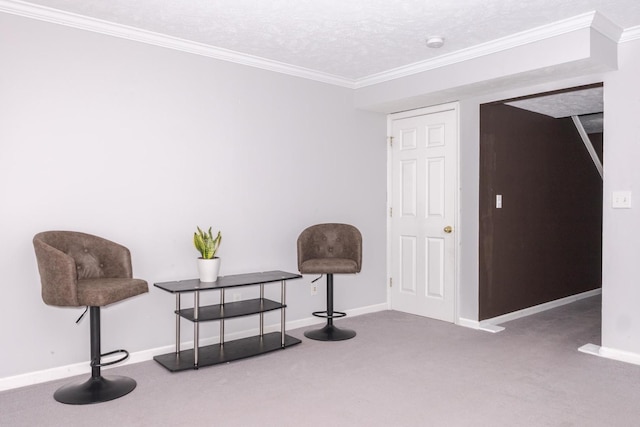 living area with baseboards, a textured ceiling, carpet flooring, and crown molding