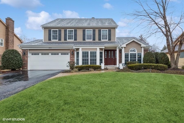 view of front of home featuring aphalt driveway, an attached garage, brick siding, and a front lawn