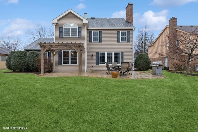 back of property with a yard, a patio, a chimney, and a pergola