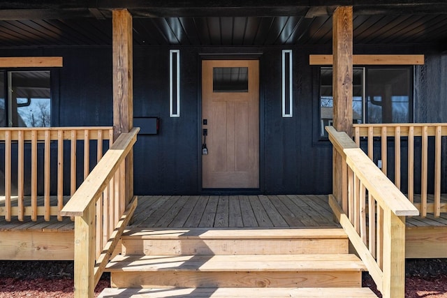 view of exterior entry featuring a porch