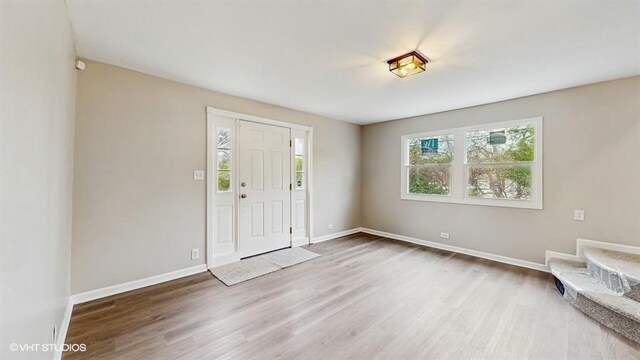 foyer entrance featuring wood finished floors and baseboards