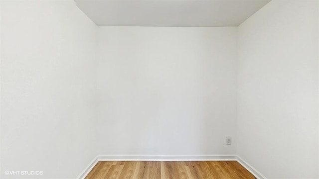 unfurnished room featuring baseboards and light wood-style flooring