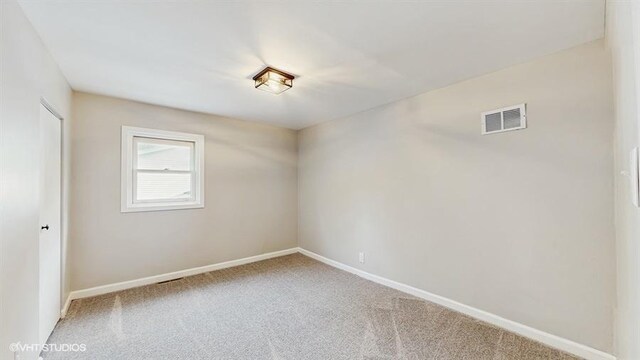 spare room with carpet floors and baseboards