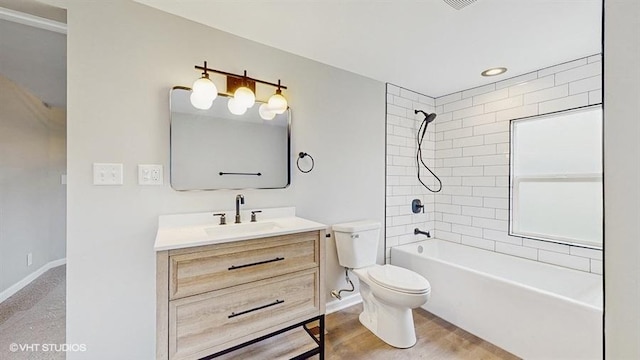 bathroom with vanity, toilet, shower / bath combination, and baseboards