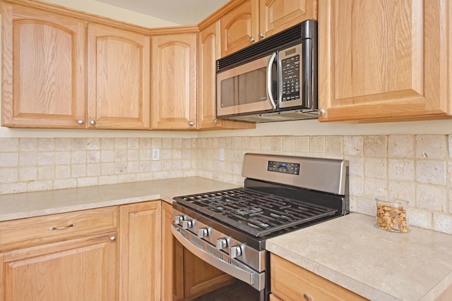 3916 Tallgrass Dr, Champaign, IL 61822 - kitchen featuring light countertops, backsplash, appliances with stainless steel finishes, and light brown cabinets