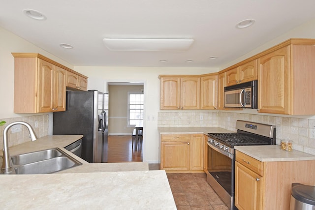 3916 Tallgrass Dr, Champaign, IL 61822 - kitchen with light countertops, backsplash, appliances with stainless steel finishes, and a sink