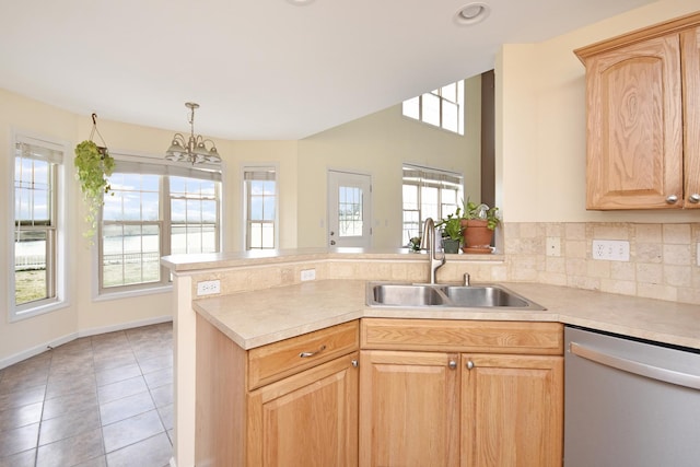 3916 Tallgrass Dr, Champaign, IL 61822 - kitchen featuring stainless steel dishwasher, a peninsula, light brown cabinetry, a sink, and a wealth of natural light