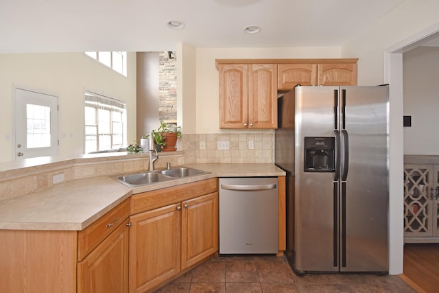 3916 Tallgrass Dr, Champaign, IL 61822 - kitchen with decorative backsplash, a peninsula, light countertops, a sink, and appliances with stainless steel finishes