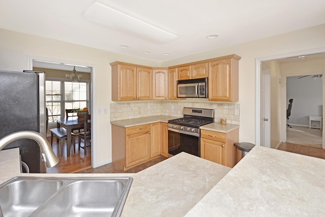 3916 Tallgrass Dr, Champaign, IL 61822 - kitchen featuring a sink, light brown cabinetry, stainless steel appliances, and light countertops