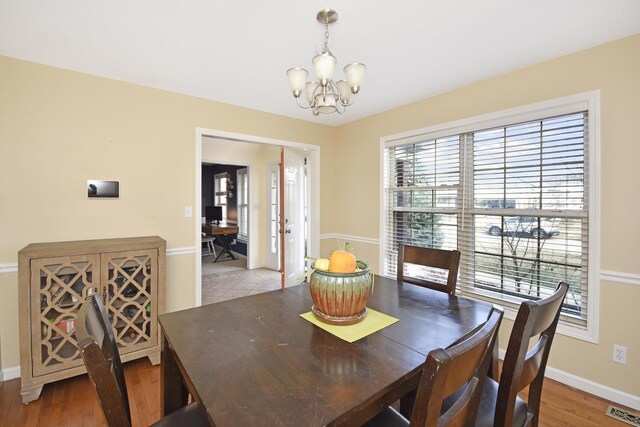 3916 Tallgrass Dr, Champaign, IL 61822 - dining area with an inviting chandelier, baseboards, light wood finished floors, and visible vents