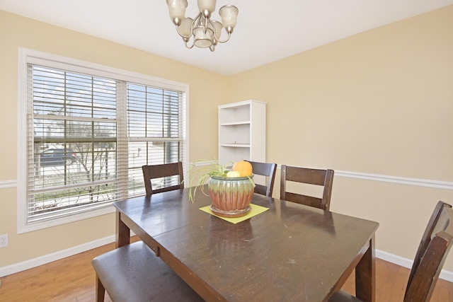 3916 Tallgrass Dr, Champaign, IL 61822 - dining space featuring baseboards, a chandelier, and wood finished floors