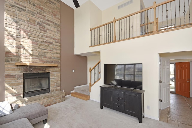 3916 Tallgrass Dr, Champaign, IL 61822 - carpeted living room featuring visible vents, a towering ceiling, a fireplace, baseboards, and stairway