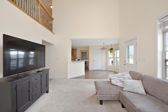 3916 Tallgrass Dr, Champaign, IL 61822 - living room featuring baseboards, a notable chandelier, plenty of natural light, and a towering ceiling