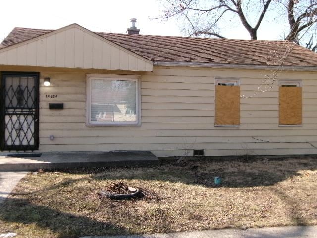 view of home's exterior with a shingled roof